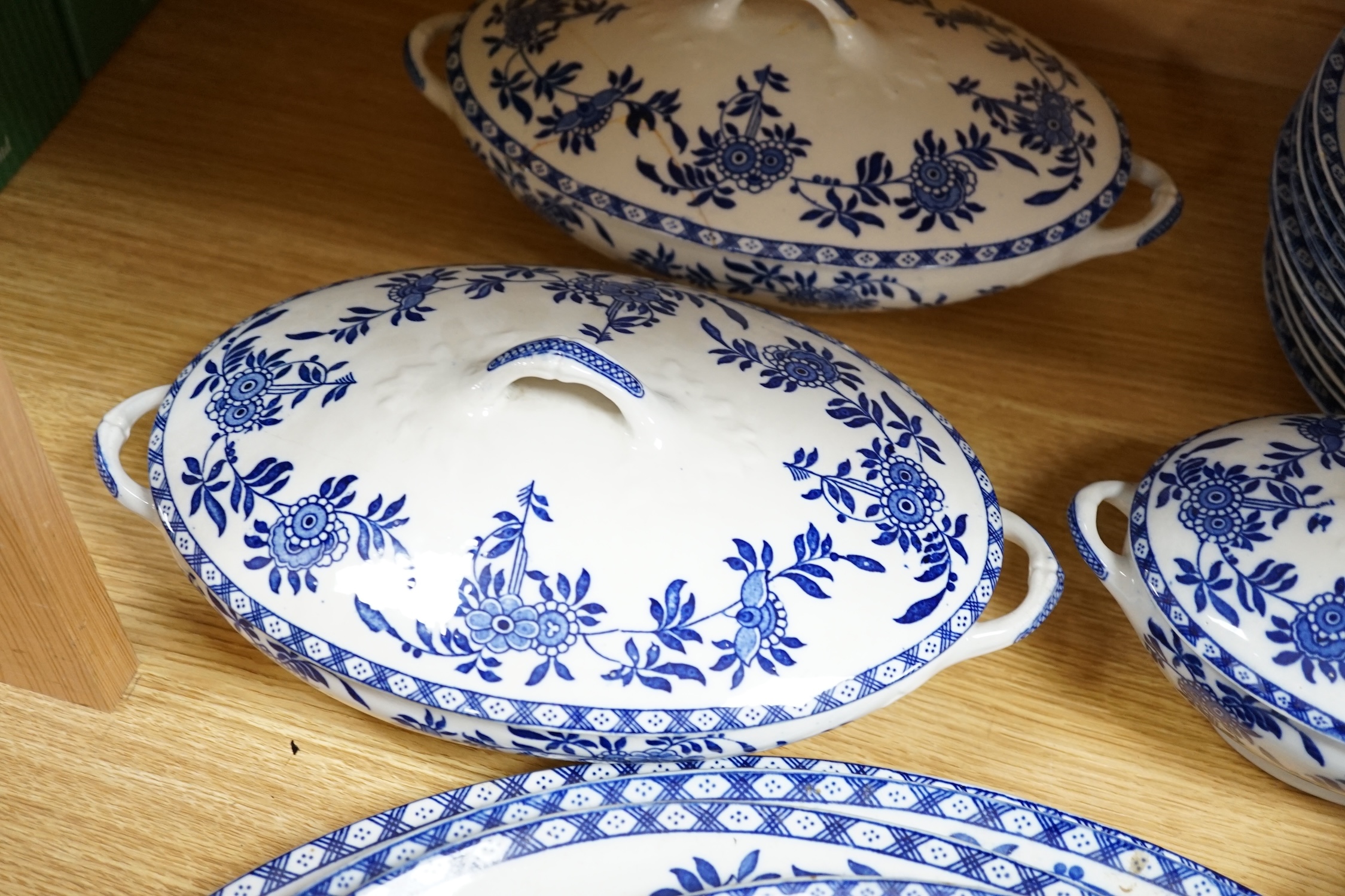 A mixed Wood and Sons ‘Delph’ patterned blue and white dinner service, including oval meat platters, various sized plates and two pairs of tureens and covers. Condition - fair to good